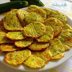 a white plate topped with sliced up zucchini