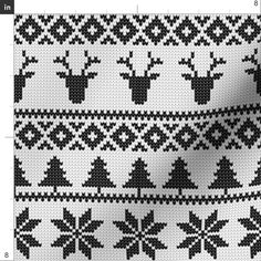 a knitted pattern with deers and snowflakes on the bottom, in black and white