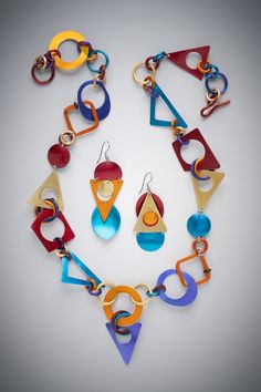 Metal Necklace & Earrings - This necklace, composed of triangles, rings, discs & ovals,  is handcrafted, anodized & dyed by the artist in hot colors. This playful necklace is comfortable to wear as it weighs practically nothing & dances around the neck.Hook clasp closure.Available in 20, 22, or 24. Modern Multicolor Jewelry With Unique Variations, Modern Multicolor Geometric Jewelry, Modern Multicolor Jewelry With Bold Design, Bold Geometric Jewelry For Gifts, Unique Multicolor Geometric Jewelry, Recycled Earrings, Playful Jewelry, Aluminum Can Crafts, Aluminum Jewelry