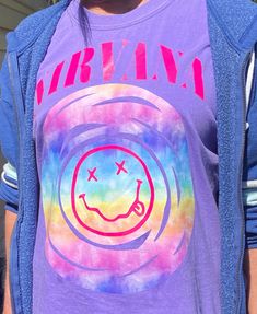 First time buyers to my shop can use promo code FIRSTORDERTHANKYOU for an ADDITIONAL 10% off of your first order!  Nirvana 90's Grunge Band T Shirt with Nirvana Smiley Face. Customizable & personazible. Message me with any questions. Prints on great quality t shirts.  Color pictured is Comfort Colors Violet. Your color choice of design/text. Classic cotton crew (100% cotton), heather soft styles & Sports Gray (65% polyester & 35% cotton or 50/50) and comfort colors (100% ring-spun cotton) available for t shirt. See shirt color images in pictures. Adult sizes come in small, medium, large, X large & 2 XL (check with me on brand & color for the larger sizes). Youth sizes come in small, medium & large. Ask me about infant or toddler sizes. Y2k Style Cotton T-shirt For Music Festival, Y2k Cotton T-shirt For Music Festivals, Grunge Style Festival T-shirt For Spring, Spring Festival Grunge T-shirt, Trendy Cotton Festival T-shirt, Unisex Festival T-shirt With Screen Print, Purple Grunge T-shirt For Summer, Hippie Style Screen Print T-shirt For Festival, Hippie Style Festival T-shirt With Screen Print