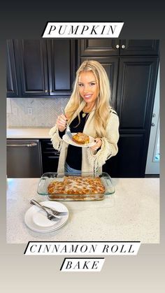 a woman standing in front of a table holding a plate of food with the words pumpkin cinnamon roll bake on it