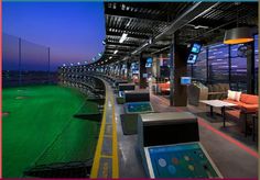 the inside of a sports stadium with seating and television screens on the sidelines at night