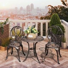 two chairs and a table on a balcony