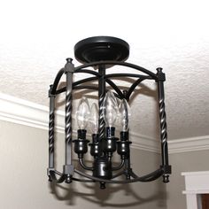 a chandelier hanging from the ceiling in a room with two lights on it