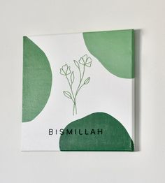 a green and white book with flowers on the cover that reads, bismillah