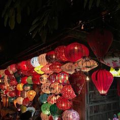 many colorful lanterns are hanging from the ceiling