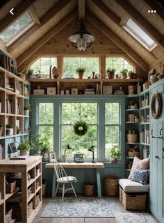 a room filled with lots of wooden shelves and furniture next to a window covered in plants