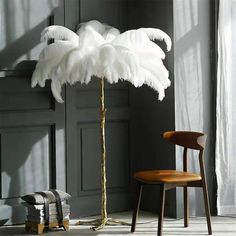 an ostrich standing next to a chair in front of a door with white feathers on it