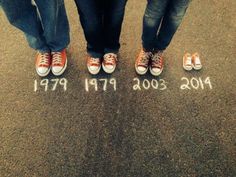 three people standing in the street with their feet up and writing on the ground below them