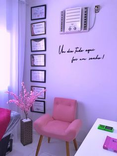 a pink chair sitting in front of a wall with pictures and writing on the walls