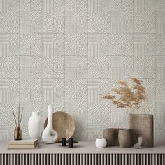 a shelf with vases and other decorative items on it, along with a wallpaper pattern