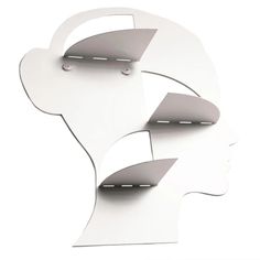 two white paper cutouts with the shape of a woman's head and ear