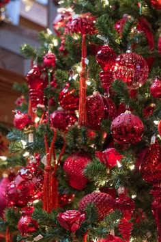 a christmas tree with red ornaments and lights