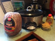 an open crock pot sitting on top of a counter next to other cooking utensils