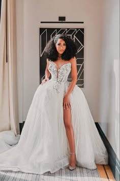 a woman in a wedding dress posing for the camera