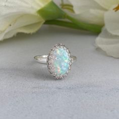 An absolutely gorgeous white opal gemstone ring. This victorian style sterling silver setting showcases a large 14x10mm oval opal. The pinfire in this opal is beautiful in the light and flashes a multitude of colours. This ring comes ready for gifting in a white jewelry box. A silver polishing cloth is included with your purchase. This ring makes a beautiful gift for those born in October, or anyone who loves the beauty of a classic opal. Gemstone: White Opal, Lab Gemstone Size: 14x10mm Ring Siz Vintage Opal Ring, Opal Stone Ring, Antlers Decor, Opal Ring Vintage, Sterling Silver Opal Ring, Born In October, Preppy Jewelry, Silver Opal Ring, White Opal Ring