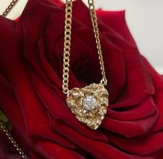 "14K Yellow Gold Nugget Heart with .30CT Natural Diamond on a Curb Chain Necklace The nugget heart is set with a single .30carat round brilliant cut diamond, VS clarity, F color. The pendant is 19x14mm, and the chain is 20\" long, and 2mm wide. The chain can be shorted by request. 6.5 grams in total." Gold Nugget Necklace, Heart-shaped Rose Cut Diamond Jewelry For Formal Occasions, Heart-shaped Rose Cut Diamond Jewelry For Formal Events, Formal Heart-shaped Jewelry With Rose Cut Diamonds, Formal Heart-shaped Rose Cut Diamond Jewelry, Yellow Gold Heart-shaped Jewelry With Rose Cut Diamonds, Yellow Gold Heart-shaped Rose Cut Diamond Jewelry, The Nugget, Nugget Necklace