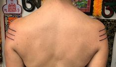 the back of a woman's neck with lines drawn on her upper part and bottom part