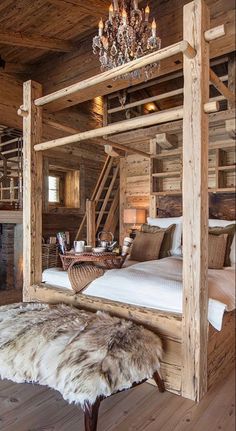 a rustic bedroom with wooden walls and flooring is decorated in natural wood, including a canopy bed