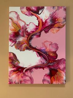 an abstract painting with pink and red flowers on a beige background, hanging on a wall