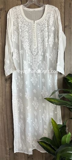 "Trendy \"ghaas patti \" Chikankari white kurta on fine flowy georgette. Beautifully hand embroidered! Liner included. Kurti length-49 inches \"Embroidery designs may slightly vary\"" Luxury Chikankari Embroidery Tunic Dress, Luxury Feminine Chikankari Embroidery Sets, Luxury Chikankari Embroidered Top For Summer, Luxury Chikankari Embroidery Top For Party, Luxury Chikankari Embroidery Blouse For Festive Occasions, Luxury Chikankari Embroidered Top For Wedding, Luxury Chikankari Embroidery Georgette Dupatta, Bohemian Off White Straight Kurta, Long Kurta With Chikankari Embroidery For Summer