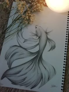 a pencil drawing of a fish next to some flowers and a candle on a table