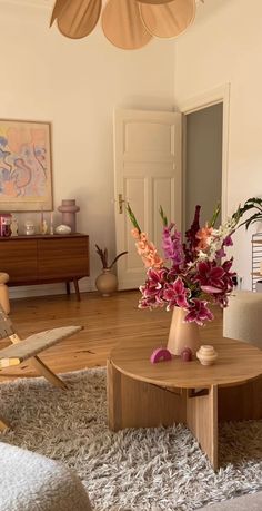 a living room filled with furniture and flowers