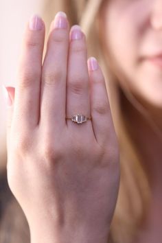 a close up of a person holding a ring