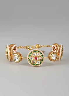 This elegant Gold Plated Dark Green Stone Meenakari and Kundan Bangle is crafted from high-quality brass and features a luxurious gold plating that enhances its elegance. Adorned with intricate Meena painting and stunning kundan work, this piece showcases a perfect blend of traditional artistry and contemporary design, making it a striking addition to any jewelry collection. Ideal for Mehendi or Sangeet, this bangle is sure to elevate your style with its unique charm and sophistication. Composition : Mixed Metal, Meenakari painting and Kundan work Care: Keep away from water and perfume Delivery : 2-3 weeks as the product is hand crafted. For more information and sizes please contact fabiliciousfashion@gmail.com or visit our Copenhagen studio. About the Designer : Nyela was founded by siste Meenakari Painting, Entrepreneurial Skills, Kundan Work, Kundan Bangles, Indian Wedding Wear, Buy Gold, Affordable Jewelry, Mixed Metals, Green Stone