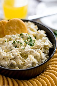 a close up of a bowl of food with crackers