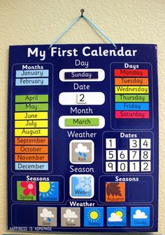 a blue calendar hanging on a wall with the words my first calendar written below it