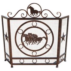 an iron fire screen with horses running through the center and stars in the middle on each side