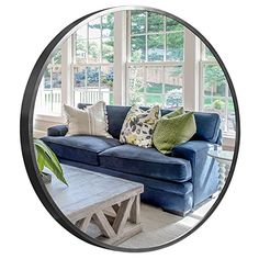 a living room with a blue couch and coffee table in front of a large window