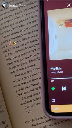 an open book with text on it and a cell phone showing the page in spanish