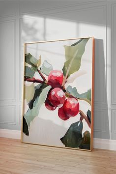 an oil painting of cherries hangs on the wall next to a hardwood floor in front of a white paneled wall