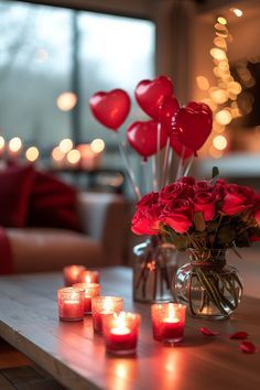 valentine's day candles and roses in a vase on a coffee table