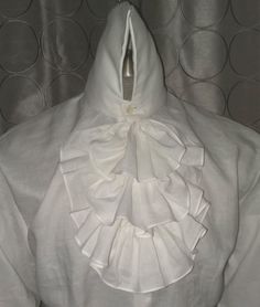 Here we have combined an 18th Century Collar and Neck Ruffles with a modern fit body in an excellent 100% linen. Made with a modern fit body for comfort, with real mother of pearl shell buttons Extra high collar is sculpted in back, for easy wear Shoulder yoke has a pleat at center back Cuffs can be folded back for French cuff effect, or left down for the Poet's sleeve look. Order by Neck, chest and sleeve measurements Elegant White Linen Shirt, Fitted White Shirt With Ruffled Collar, White Fitted Shirt With Ruffled Collar, White Linen Formal Shirt, Formal White Linen Shirt, Elegant Shirt With Fitted Ruffled Collar, Elegant Fitted Shirt With Ruffled Collar, White Linen Top For Formal Occasions, White Formal Shirt With Ruffled Collar