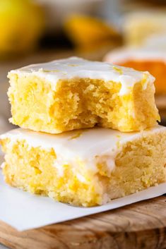 two pieces of yellow cake sitting on top of a cutting board next to each other