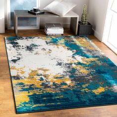 a blue and yellow area rug in a living room