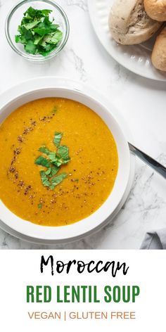 a white bowl filled with red lentil soup and garnished with cilantro