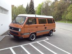 an orange van parked in a parking lot