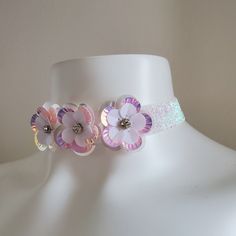 "This choker is made of lightweight white iridescent elastic. There are three sequin flowers hand sewn onto the front. It is adjustable with a back hook and chain. Length: 12\" elastic Adjusts up to 20\" Width: 1\" wide elastic Message us for custom design requests! SHIPPING Ships from Los Angeles Instagram @BEXI_APPAREL" Adjustable Flower Necklace For Party, White Flower Decorated Necklaces For Party, Adjustable Party Choker With Flower Decoration, Adjustable Flower Decoration Choker For Party, Adjustable Flower Decorated Party Choker, White Flower Necklace For Party, Adjustable Silver Flower Necklace For Party, Adjustable White Flower Necklace, White Adjustable Flower Necklace