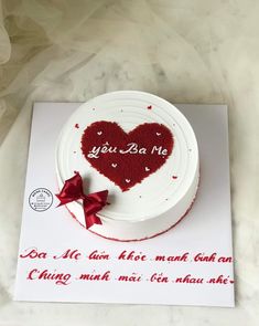 a white cake with red icing and a heart on top that says you ba me