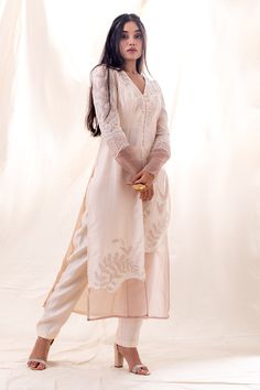 Ivory kurta with glass beads, pearls and sequins applique embroidery. Comes with straight pant.
Components: 2
Pattern: Embroidered
Type Of Work: Glass beads, Pearls, Sequins
Neckline: V Neck
Sleeve Type: Full
Fabric: Kurta : Chanderi and Organza, Pant : Chanderi
Color: Ivory
Other Details: 
Side slits on kurta
Closure : Front buttons
Occasion: Mehendi and Haldi - Aza Fashions Sequin Appliques, Indian Fashion Designers, Pernia Pop Up Shop, Fashion App, Sequins Embroidery, Pink Pearl, Pant Set, Straight Pants, Set For Women