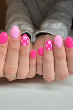 Fun and Flirty: Vibrant Pink Oval Nails with a Checkered Accent Nail Design - A playful mix of bold pinks and soft pastels, enhanced with a charming geometric pattern, perfect for a pop of color and subtle twist! // Photo Credit: Instagram @nailsbylexih Purple Nails Checkered, Cute Short Oval Acrylic Nails, Nail Ideas Checkerboard, Round Nail Ideas Summer, Short Striped Nails, Short Nail Cute Designs, Cute Fun Summer Nails, Checkered Accent Nails, Summer Gel Nails Round