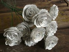 paper flowers sitting on top of a wooden table