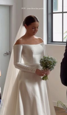 a woman in a wedding dress holding a bouquet