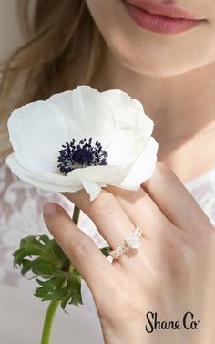 a close up of a person holding a flower