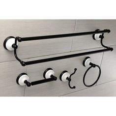 two black and white towel racks on the wall with handles for towels or toilet paper