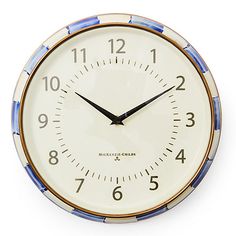 a blue and white clock with numbers on it's face is shown in front of a white background